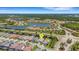 Community aerial view of homes near a peaceful lake surrounded by mature trees, showcasing serene living at 204 Corelli Dr, Nokomis, FL 34275