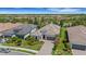 An aerial view of a beautiful neighborhood, showcasing lush landscaping and well-maintained homes at 204 Corelli Dr, Nokomis, FL 34275