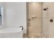 Bright bathroom with freestanding tub and glass enclosed shower with stone floor and rainfall shower head at 204 Corelli Dr, Nokomis, FL 34275