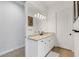 Beautiful bathroom with a white vanity, granite countertops, and modern lighting at 204 Corelli Dr, Nokomis, FL 34275