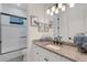 Well-lit bathroom features granite countertop, modern fixtures, and a shower-tub combination behind a glass door at 204 Corelli Dr, Nokomis, FL 34275