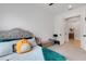 Cozy bedroom with a tufted headboard, a charming stuffed animal and doorway to the rest of the home at 204 Corelli Dr, Nokomis, FL 34275