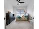Bright bedroom featuring a ceiling fan, neutral carpet, and a large window for ample natural light at 204 Corelli Dr, Nokomis, FL 34275