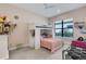 This cozy bedroom features a white bunk bed, a window with natural light, and neutral colored walls and carpet at 204 Corelli Dr, Nokomis, FL 34275