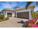 Beautiful home featuring a three-car garage and meticulously manicured landscaping at 204 Corelli Dr, Nokomis, FL 34275