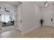Elegant hallway featuring light wood floors and a view into the nicely decorated bedroom at 204 Corelli Dr, Nokomis, FL 34275