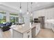 Open-concept kitchen with large island, stainless appliances, and a seamless flow to living spaces at 204 Corelli Dr, Nokomis, FL 34275