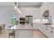 Bright kitchen with granite countertops, stainless steel appliances, and a functional center island at 204 Corelli Dr, Nokomis, FL 34275
