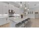 Modern kitchen with white cabinets, granite counters, and seating at island at 204 Corelli Dr, Nokomis, FL 34275