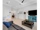 Cozy living room featuring wood flooring, an entertainment center, and a comfortable seating arrangement at 204 Corelli Dr, Nokomis, FL 34275