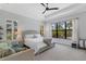 Bright bedroom with a ceiling fan and a large window that provides plenty of natural light at 204 Corelli Dr, Nokomis, FL 34275