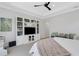 Comfortable bedroom with white furniture, wall-mounted TV, and decorations at 204 Corelli Dr, Nokomis, FL 34275