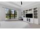 Bright bedroom with a pool view, entertainment center and white furniture at 204 Corelli Dr, Nokomis, FL 34275