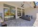 This open patio features outdoor wicker furniture, tile flooring, a ceiling fan and is near a pool at 204 Corelli Dr, Nokomis, FL 34275