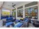 An open patio features a wicker couch and chairs, a grill, an outdoor kitchen, and views of the pool at 204 Corelli Dr, Nokomis, FL 34275