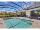 Relaxing outdoor pool area with screened-in patio, lush greenery, and comfortable seating at 204 Corelli Dr, Nokomis, FL 34275