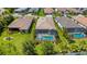 Aerial view of the backyard featuring a screened-in pool and lush green landscaping at 204 Corelli Dr, Nokomis, FL 34275