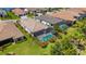 Aerial view of backyard featuring a screened-in pool and lush green landscaping at 204 Corelli Dr, Nokomis, FL 34275