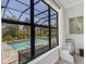 An exterior view of a pool, taken from within the home, through a large window at 204 Corelli Dr, Nokomis, FL 34275