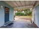 Covered back patio leading to a spacious, private backyard with mature trees at 22275 Belinda Ave, Port Charlotte, FL 33952