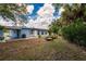Expansive backyard with a cozy seating area and lush landscaping at 22275 Belinda Ave, Port Charlotte, FL 33952