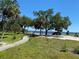 Path leading to the beach with mature trees and parking. Beach access for residents at 22275 Belinda Ave, Port Charlotte, FL 33952