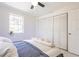 Bright bedroom featuring a window and closet with bi-fold doors plus overhead fan for added comfort at 22275 Belinda Ave, Port Charlotte, FL 33952