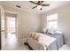 Comfortable bedroom features neutral decor, ceiling fan, and ensuite access at 22275 Belinda Ave, Port Charlotte, FL 33952
