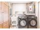 Functional laundry room with washer, dryer, utility sink, and ample storage space at 22275 Belinda Ave, Port Charlotte, FL 33952