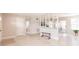 Spacious living room featuring terrazzo flooring, neutral paint, and decorative partition at 22275 Belinda Ave, Port Charlotte, FL 33952