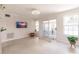 Living room with sliding glass doors, terrazzo flooring, and modern ceiling fan at 22275 Belinda Ave, Port Charlotte, FL 33952