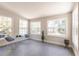 Light-filled sunroom with large windows offering peaceful backyard views at 22275 Belinda Ave, Port Charlotte, FL 33952