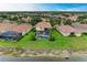 Aerial view of home with pool, lanai, and lush landscaping, nestled by a tranquil lake at 235 River Enclave Ct, Bradenton, FL 34212
