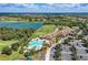 A beautiful aerial view of the community clubhouse, pool, golf course and lake at 235 River Enclave Ct, Bradenton, FL 34212