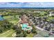 The aerial view showcases the pool, clubhouse, golf course, and lush landscaping in this community at 235 River Enclave Ct, Bradenton, FL 34212