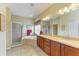 Bright bathroom with dual sinks, soaking tub, and glass shower stall at 235 River Enclave Ct, Bradenton, FL 34212