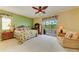Large bedroom with balcony access and a comfortable sitting area at 235 River Enclave Ct, Bradenton, FL 34212
