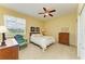 Bright bedroom with window views, chair, and chest of drawers at 235 River Enclave Ct, Bradenton, FL 34212