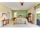 Bedroom with a large bed, side tables, a standing mirror and balcony at 235 River Enclave Ct, Bradenton, FL 34212