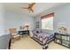 Quaint bedroom with a patriotic quilt, a rocking chair, and a ceiling fan at 235 River Enclave Ct, Bradenton, FL 34212