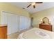 Cozy bedroom featuring two closets, wood dresser, and neutral carpet at 235 River Enclave Ct, Bradenton, FL 34212