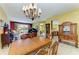 Open-concept dining room showcases chandelier, piano, and seamless flow to the living spaces at 235 River Enclave Ct, Bradenton, FL 34212