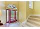 Bright foyer featuring decorative glass doorway, tile flooring, staircase, and neutral wall color at 235 River Enclave Ct, Bradenton, FL 34212