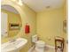 A charming half bath featuring a pedestal sink, toilet, and decorative accents at 235 River Enclave Ct, Bradenton, FL 34212