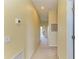 Bright hallway featuring neutral carpet, pale yellow walls, and access to the lanai at 235 River Enclave Ct, Bradenton, FL 34212