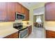 Kitchen showcases stainless steel appliances, wood cabinetry, and bright countertops at 235 River Enclave Ct, Bradenton, FL 34212