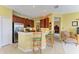 The kitchen features bar seating, stainless steel appliances, wood cabinets, and tile flooring at 235 River Enclave Ct, Bradenton, FL 34212