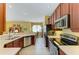 Modern kitchen with stainless steel appliances and an open view of the dining area at 235 River Enclave Ct, Bradenton, FL 34212
