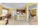 View of the kitchen area with breakfast table, barstool seating, stainless steel appliances, and tile flooring at 235 River Enclave Ct, Bradenton, FL 34212