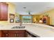 Kitchen featuring stainless appliances and a view of the living area and lake at 235 River Enclave Ct, Bradenton, FL 34212